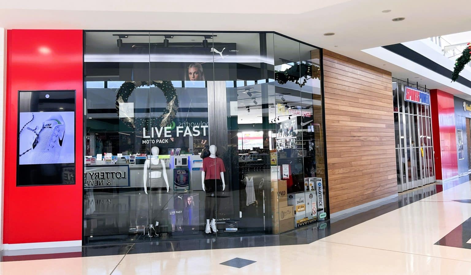Shopping centre store with athletic wear display.