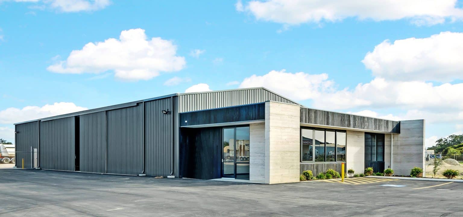 Modern grey warehouse under blue sky